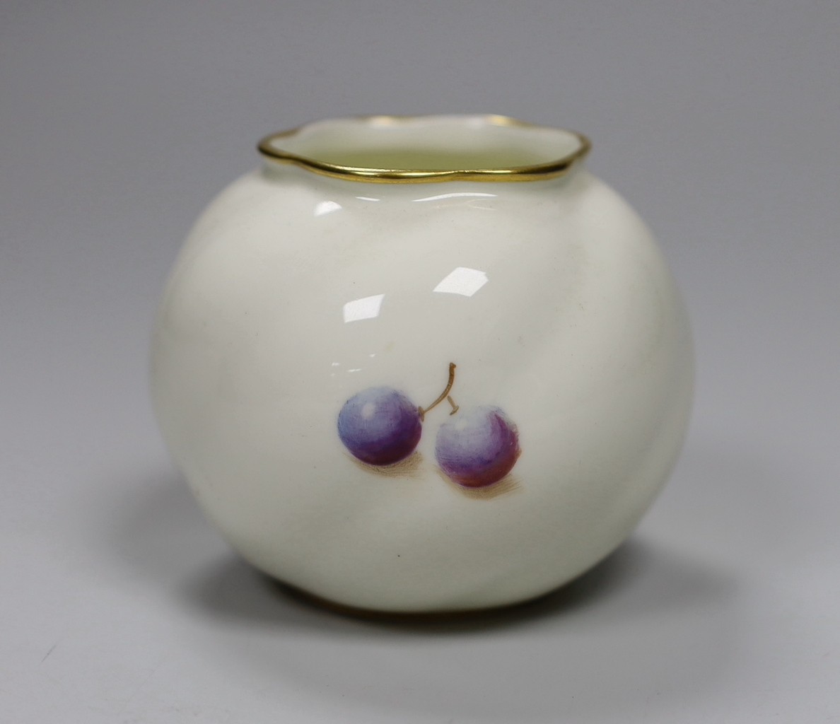 A Royal Worcester spirally moulded globular vase painted with fruits by Roberts, date code for 1955, height 7cm